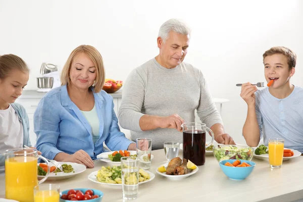 Happy family having lunch in kitchen