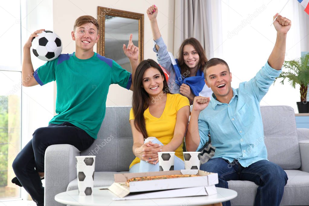 Soccer fans emotionally watching game in the room