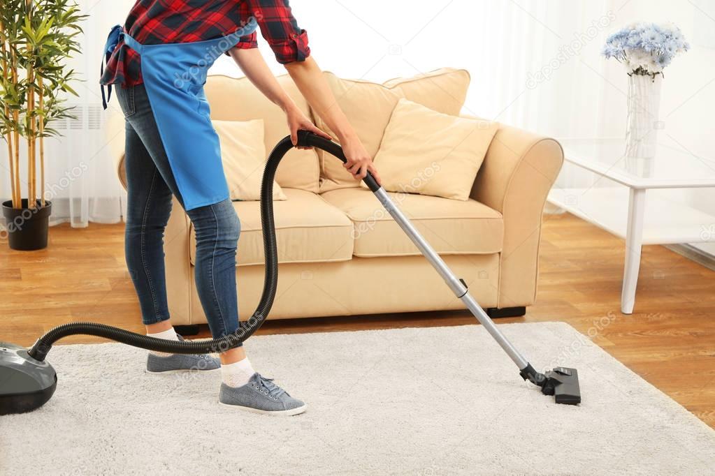 Cleaner hoovering carpet 