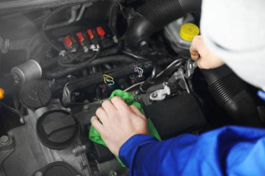 Mechanic repairing car  clipart