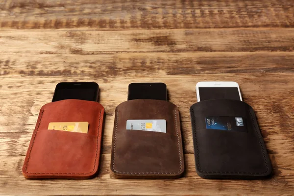 Leather cases with mobile phones — Stock Photo, Image