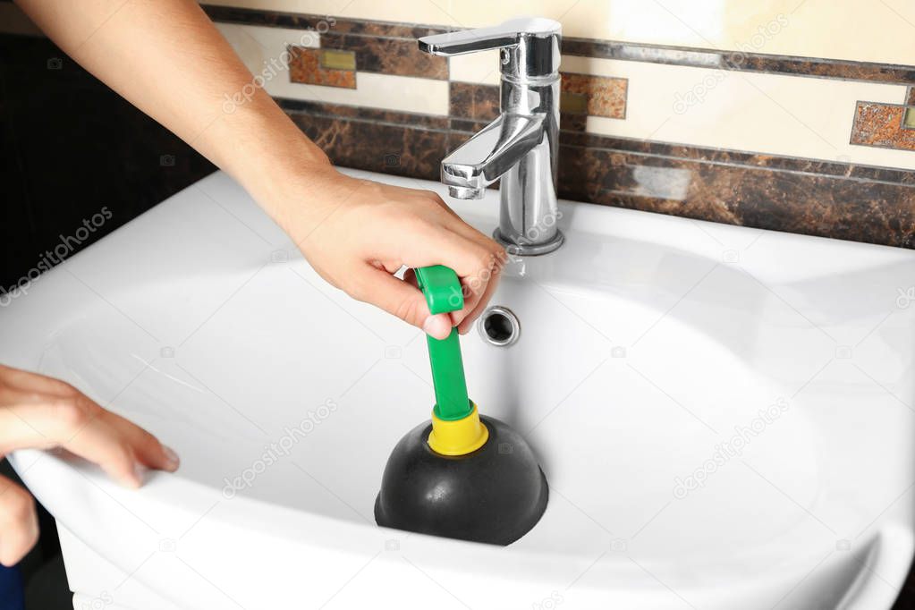 Plumber cleaning sink