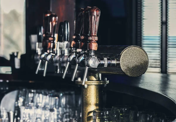 Draft beer taps in bar — Stock Photo, Image