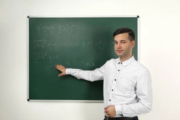 Handsome young teacher explaining — Stock Photo, Image