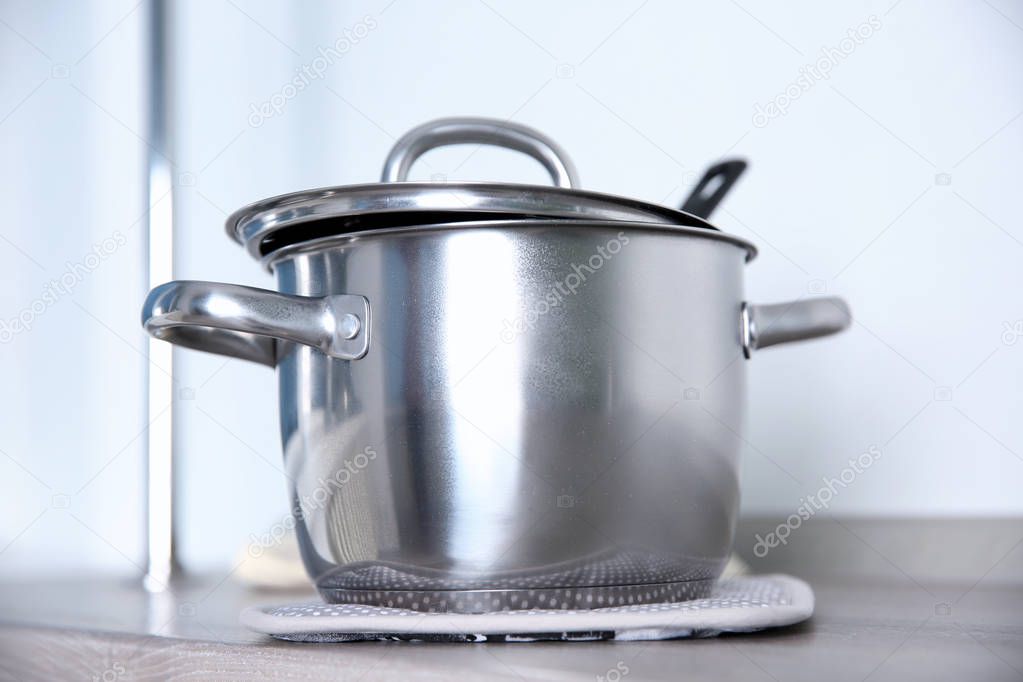 Stainless saucepan on kitchen table