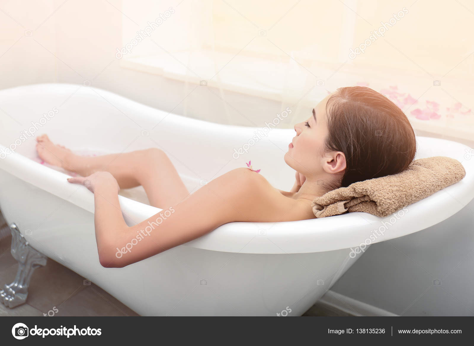 Woman taking relaxing bath Stock Photo by ©belchonock 138135236