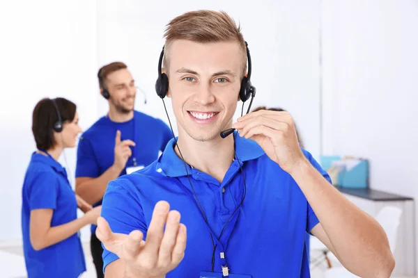 Young male technical support dispatcher working in office