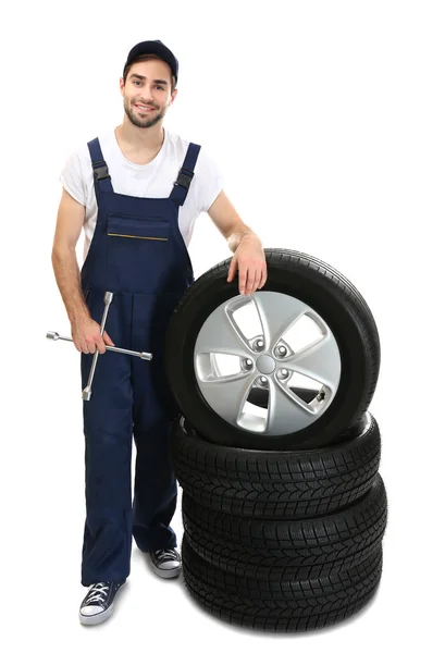 Young mechanic with wheels — Stock Photo, Image