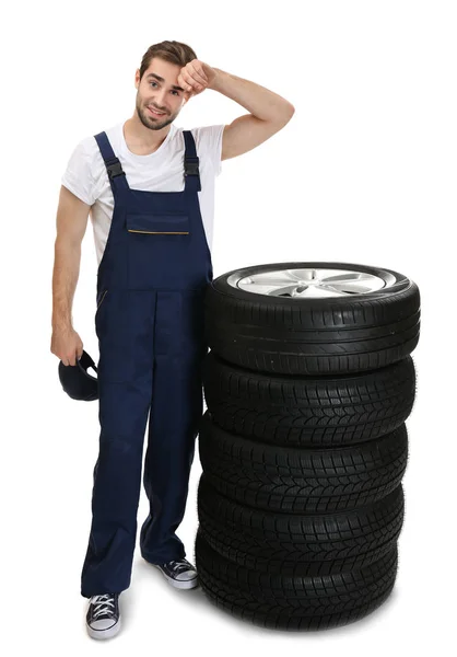 Young mechanic with wheels — Stock Photo, Image