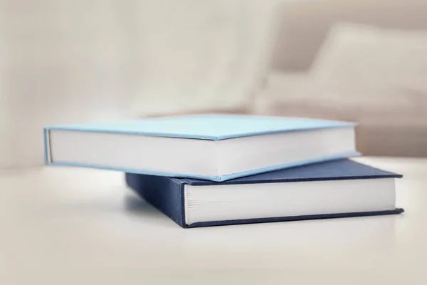 Pile of books on white table — Stock Photo, Image