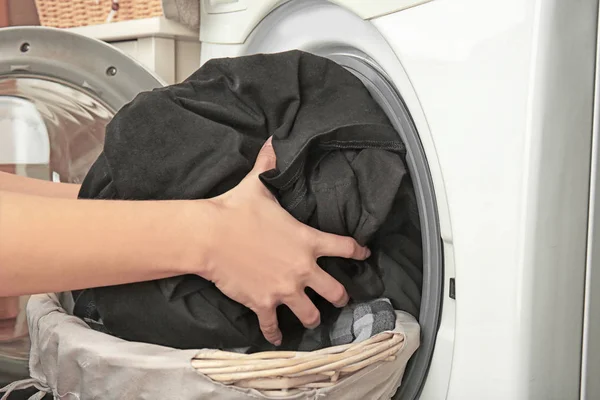 Hands getting out clean clothes — Stock Photo, Image