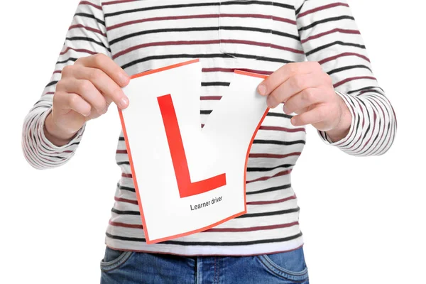 Man tearing learner driver sign — Stock Photo, Image