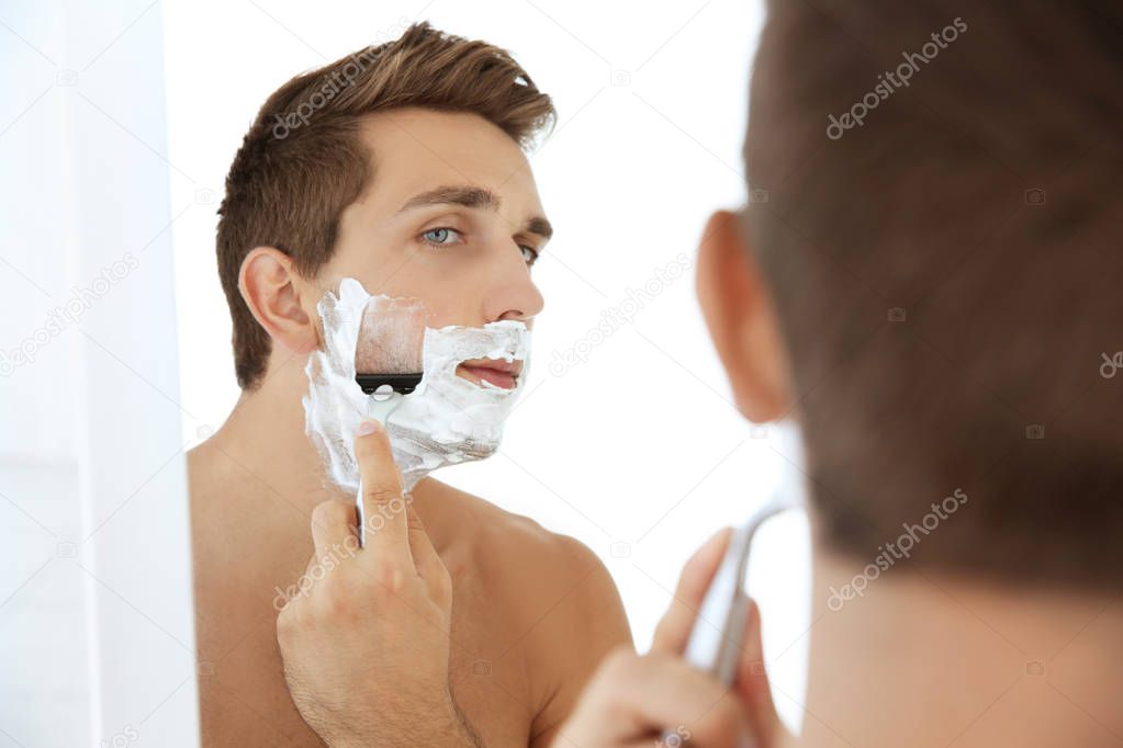 handsome man shaving