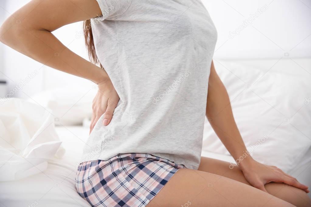Young woman with back ache