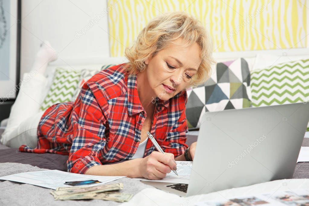 Senior woman calculating taxes 