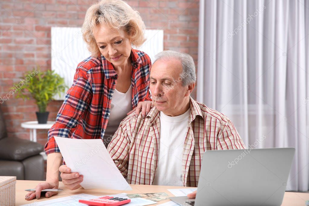 Senior couple calculating taxes 