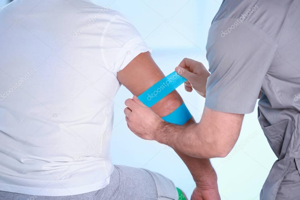 Physiotherapist applying kinesio tape 