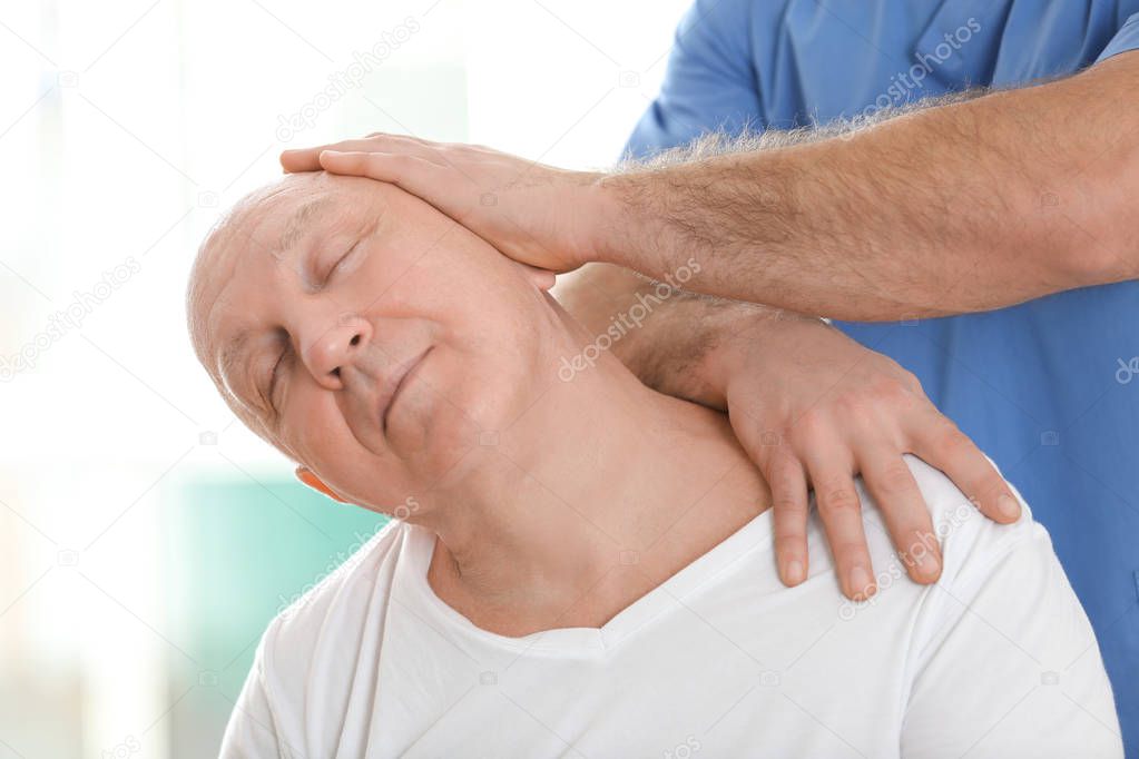 Physiotherapist working with elderly patient 