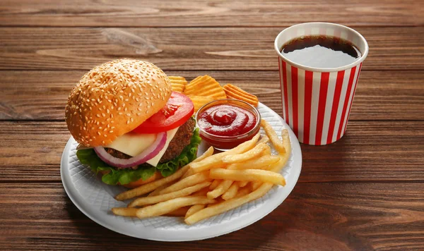 Tasty burger with snacks — Stock Photo, Image