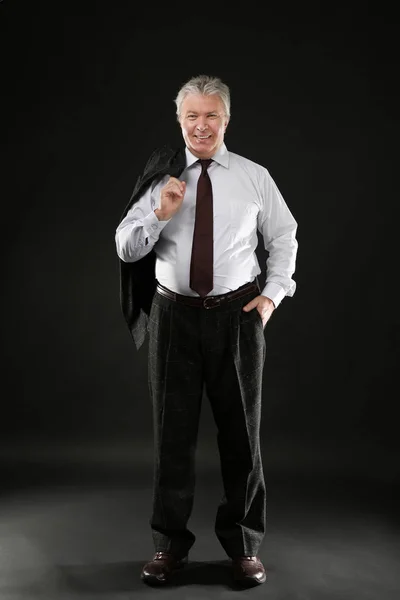 Senior businessman holding jacket — Stock Photo, Image