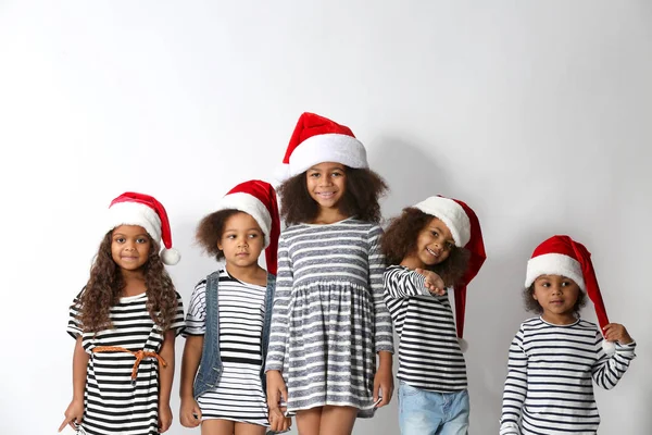 Five Cute African Girls Striped Clothes Christmas Hats White Background — Stock Photo, Image