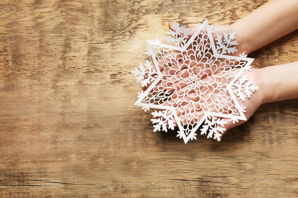 Hands with beautiful paper snowflake — Stock Photo, Image