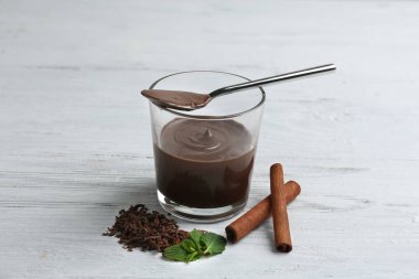 Ahşap zemin üzerine kaşık ile cam çikolata mousse