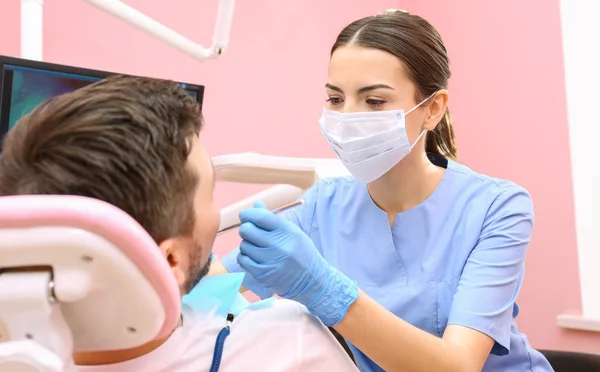 歯医者が患者の歯を調べる — ストック写真