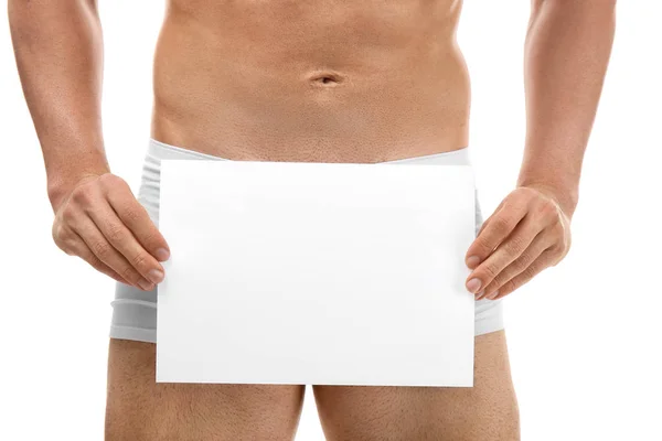 Man in boxers holding sheet of paper — Stock Photo, Image