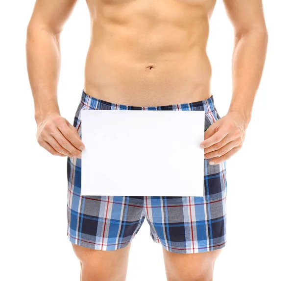 Man in boxers holding sheet of paper — Stock Photo, Image