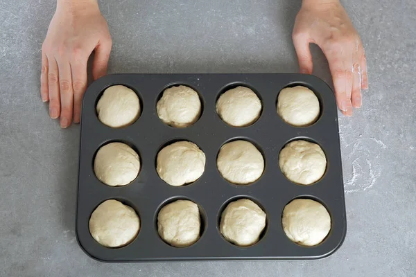 Female hands and balls of raw dough