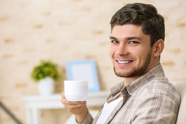 man drinking coffee at home