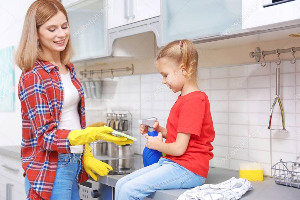woman and daughter washing electric stove 