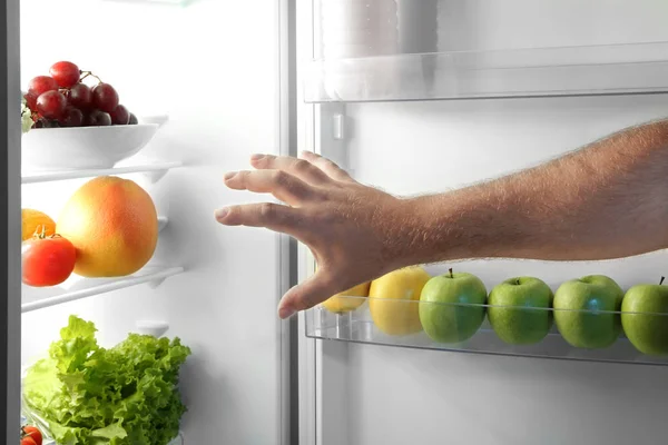 Male hand picking food — Stock Photo, Image