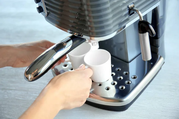 Vrouw espresso maken in koffiezetapparaat — Stockfoto