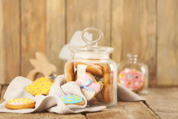 Glass jar with colourful Easter cookies — Stock Photo, Image