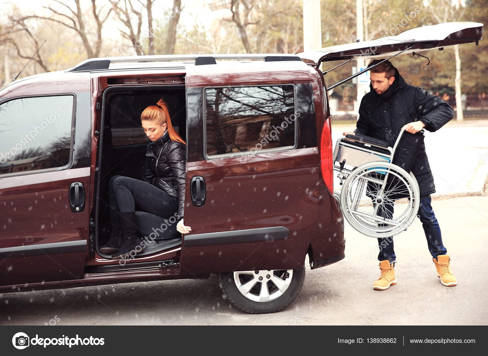 Man loading wheelchair into car — Stock Photo © belchonock 138938662