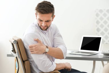 young man suffering from shoulder pain 