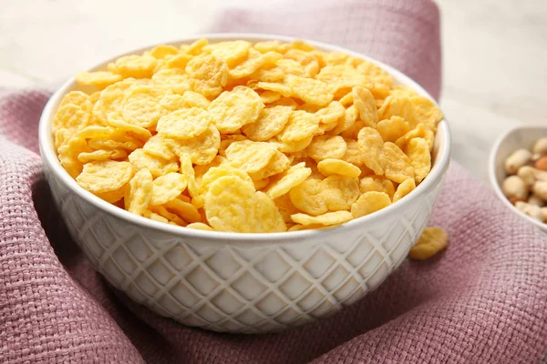 Bowl with cornflakes on napkin — Stock Photo, Image