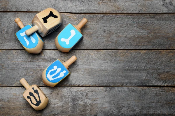 Dreidels on wooden table — Stock Photo, Image