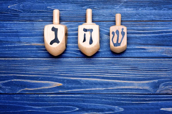 Dreidels on wooden table — Stock Photo, Image