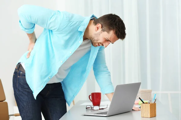 Young man suffering from backache — Stock Photo, Image