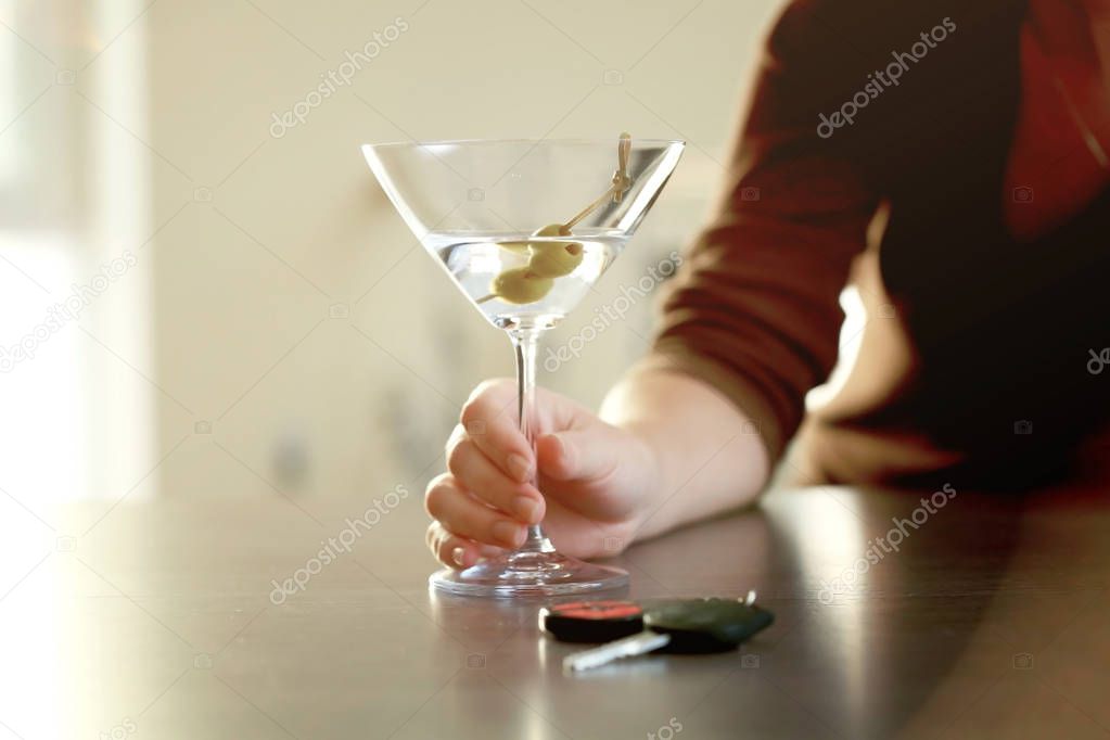 Woman with glass of alcoholic beverage