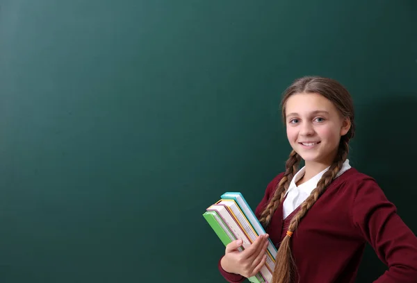 Girl near green school blackboard — Stock Photo, Image