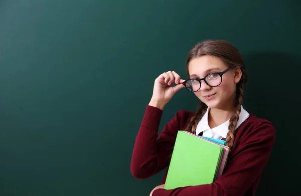 Girl near green school blackboard — Stock Photo, Image