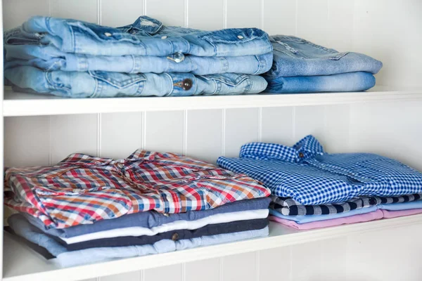 Stack of clothes on shelves — Stock Photo, Image