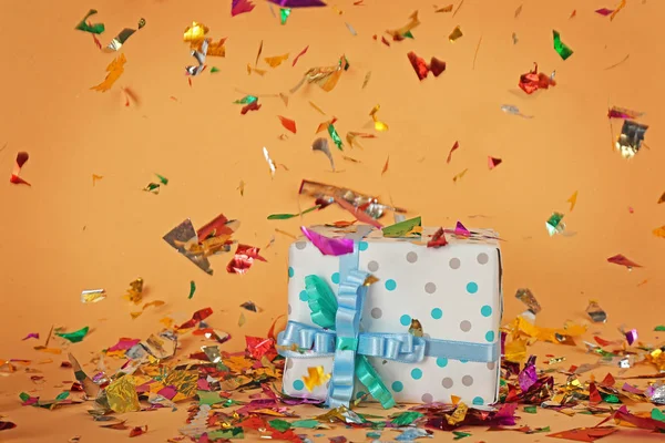 Bright confetti and gift box — Stock Photo, Image