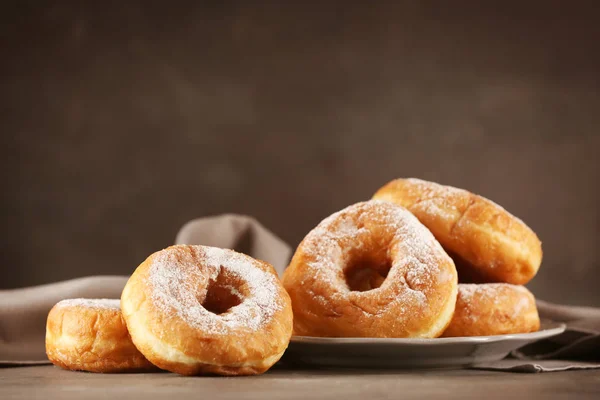 Tasty donuts with powdered sugar — Stock Photo, Image