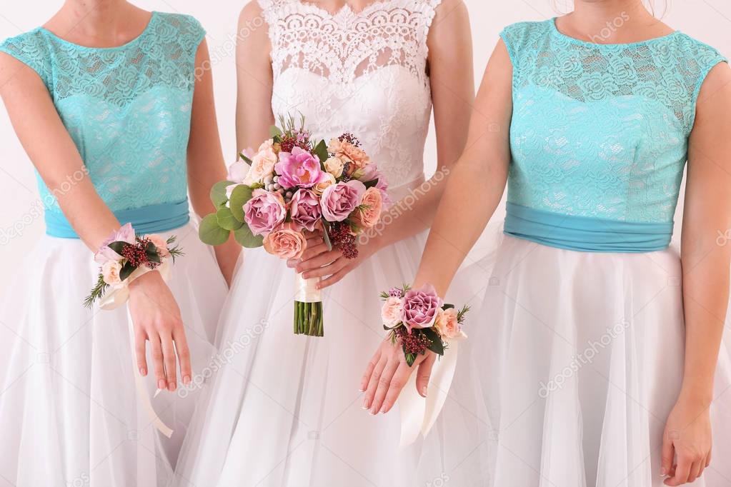 Bride holding wedding bouquet and bridesmaids 