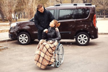 Young man with woman in wheelchair  clipart